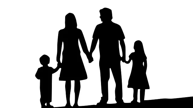 Silhouette of a family of four holding hands