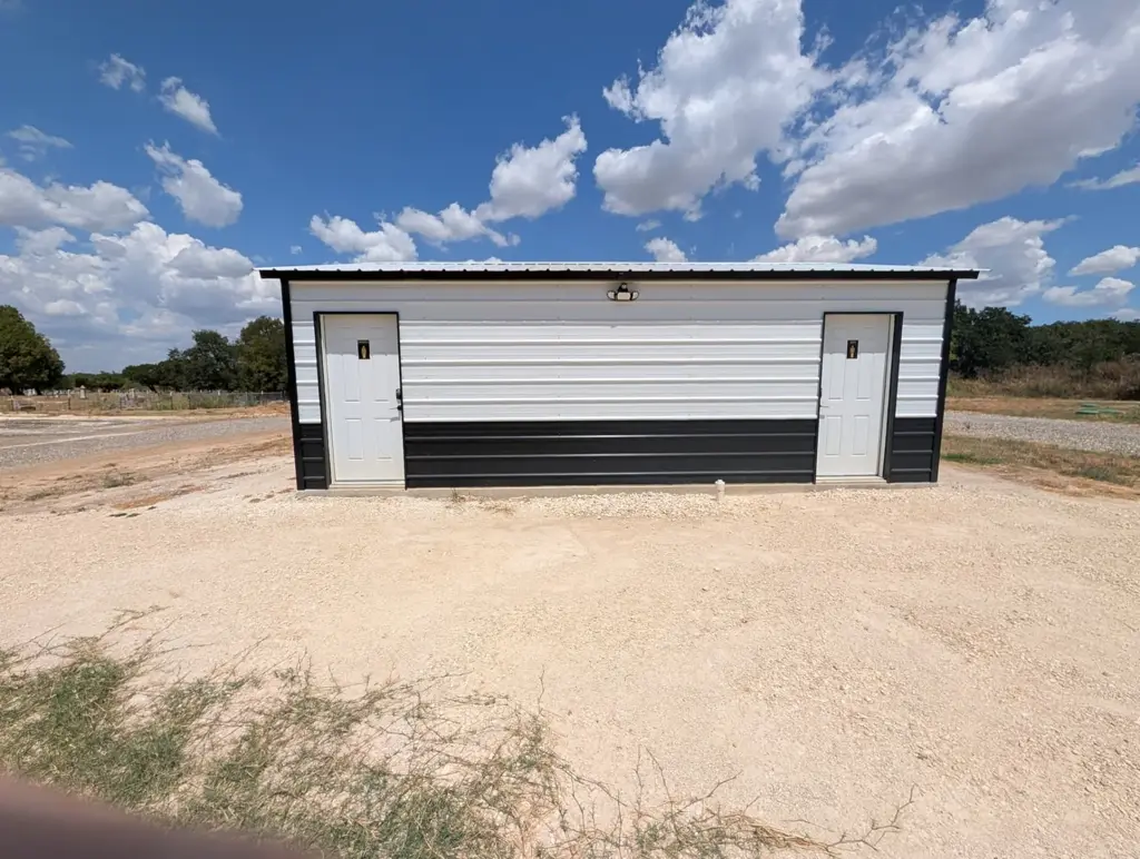 Exterior of the bathhouse at Journey's RV Park in Temple, Texas, on a sunny day with blue sky