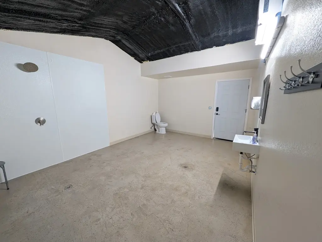 Clean, accessible restroom with walk-in shower in the bathhouse at Journey's RV Park