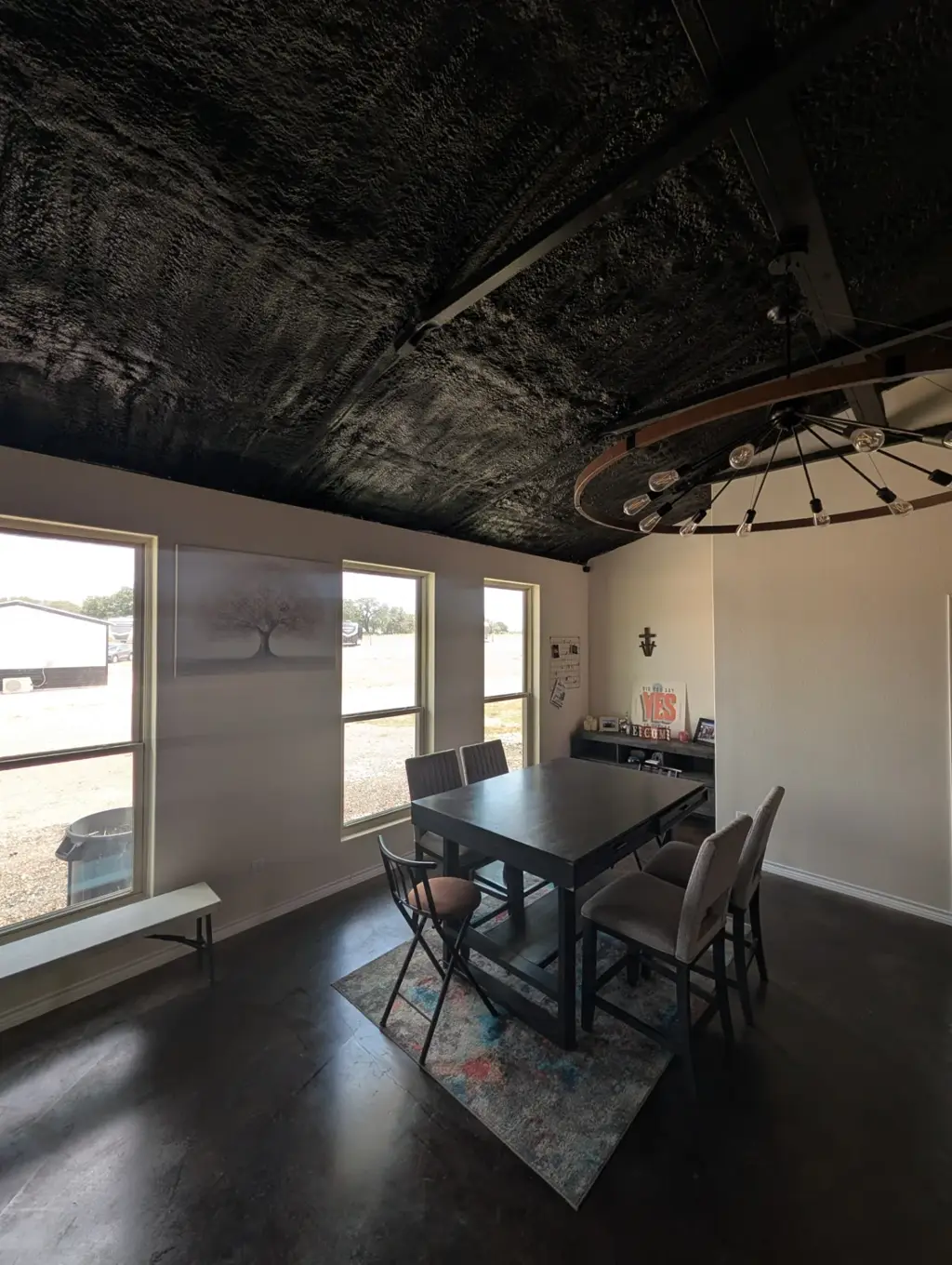 Dining area inside the Journey's RV Park event space in Temple, Texas, with a high-top table and windows overlooking the property