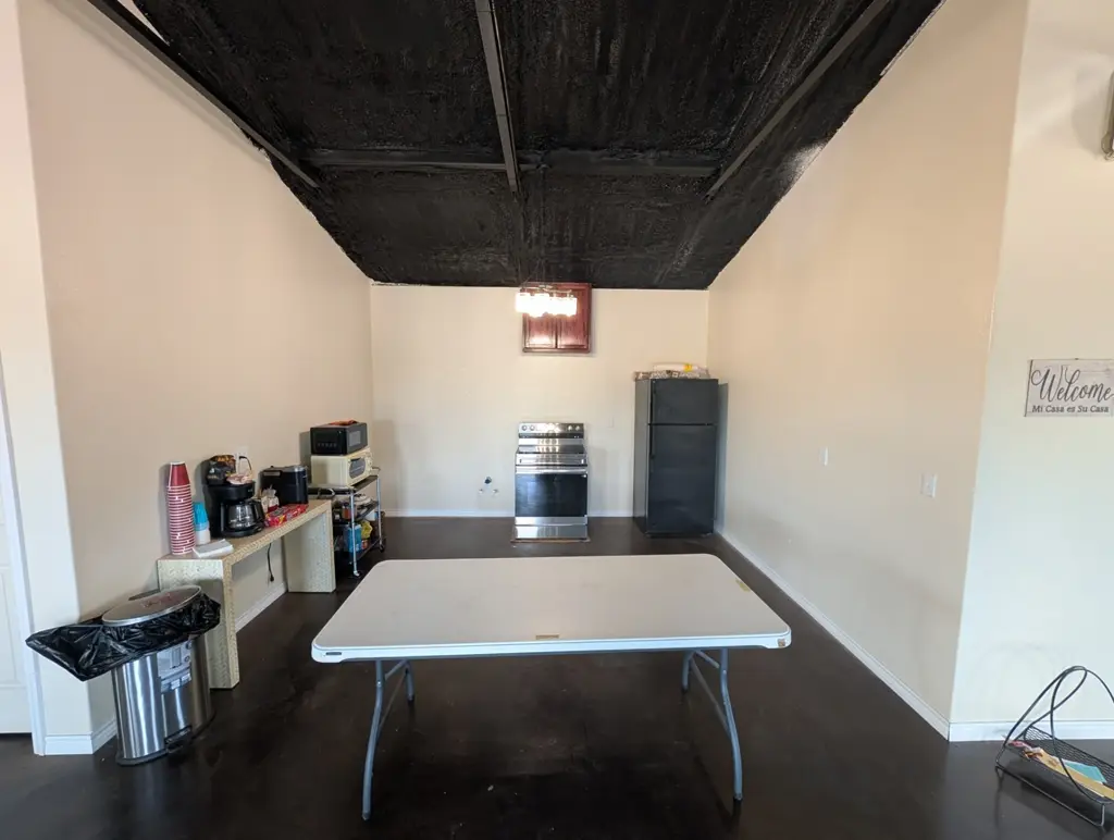 Kitchenette in the Journey's RV Park event space with refrigerator, oven, microwave, and coffee station